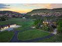 Aerial view of estate featuring luxury home, carriage house, sprawling lawns and mountain views at 9650 S Cougar Rd, Littleton, CO 80127