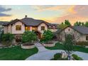Beautiful front yard with circular driveway, stone accents and lush landscaping at 9650 S Cougar Rd, Littleton, CO 80127
