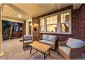 Inviting covered porch with seating area, perfect for relaxing and enjoying the neighborhood views at 1730 N Gaylord St, Denver, CO 80206
