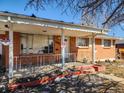 Exterior view of front porch with metal railing, brick columns and number 4291 at 4291 W Wagon Trail Dr, Littleton, CO 80123