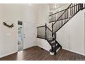 Grand entryway with hardwood floors and a staircase with dark wood railings at 650 Olympia Ave, Longmont, CO 80504