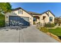 Well-maintained single-story home featuring stucco siding, stone accents, manicured landscaping, and an attached two-car garage at 11017 Meade Ct, Westminster, CO 80031