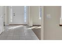 Light-filled foyer featuring tile flooring, a front door with decorative glass, and neutral paint colors at 11017 Meade Ct, Westminster, CO 80031