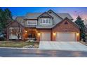 Charming home featuring a red brick facade, neutral siding, a two-car garage, and a meticulously kept lawn at 7086 Esperanza Dr, Castle Pines, CO 80108