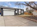 Home featuring a long driveway leading to a brick and siding facade at 16169 E Flora Pl, Aurora, CO 80013