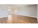 Bright living room features hardwood floors, neutral paint, and an open layout at 5876 W Canyon Ave, Littleton, CO 80128