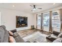 Bright living room with hardwood floors, large windows, and a custom TV stand at 9012 Borrowdale Ln, Parker, CO 80134