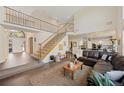 Spacious living room featuring a grand staircase, hardwood floors and ample natural light at 10 Sand Cherry, Littleton, CO 80127