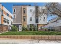 Modern townhouse with a well-manicured lawn and contemporary architectural design at 1840 Irving St, Denver, CO 80204