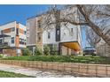 Modern townhouse with car port, well-manicured lawn, and contemporary architectural design at 1840 Irving St, Denver, CO 80204