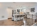 Bright kitchen featuring stainless steel appliances, a center island with bar seating, and modern light fixtures at 1840 Irving St, Denver, CO 80204
