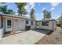 Backyard features a concrete patio area, white siding, and a separate building at 5240 Dudley St, Arvada, CO 80002