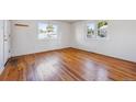 An empty bedroom featuring gleaming hardwood floors and plenty of natural light at 5240 Dudley St, Arvada, CO 80002