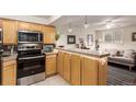 Well-equipped kitchen with stainless appliances, granite counters and light wood cabinets open to the living area at 1833 N Williams St # 101, Denver, CO 80218