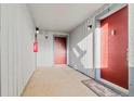 Exterior hallway with red doors, numbered 3 and 4, and a doormat at 14046 E Stanford Cir # I04, Aurora, CO 80015