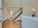 Welcoming entryway with hardwood floors and staircase with metal railing at 4351 E 109Th Ave, Thornton, CO 80233