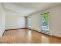 Bright and airy living room with hardwood floors and large windows at 4351 E 109Th Ave, Thornton, CO 80233