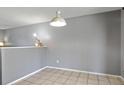 Bright dining room with tiled floors and a modern light fixture, ideal for Gathering meals at 9375 W David Ave, Littleton, CO 80128