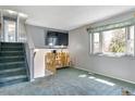 Cozy loft area featuring a large window, gray walls, and soft carpet, perfect for relaxing at 9375 W David Ave, Littleton, CO 80128