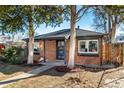 Cozy brick house with mature trees, offering shade and curb appeal at 832 Dahlia St, Denver, CO 80220