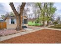 Street view of the home highlighting the manicured front yard, mature trees, and neighborhood charm at 504 Martin St, Longmont, CO 80501