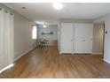 Open living area with hardwood floors, neutral walls, a dining set, and access to sliding door at 2201 Sable Blvd # 1007, Aurora, CO 80011