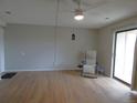 View of living room with hardwood floors, sliding glass door, ceiling fan, and stylish lantern at 2201 Sable Blvd # 1007, Aurora, CO 80011