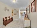 Inviting entryway with tiled floors, bench seating, and decorative mirrors creating a warm and welcoming ambiance at 2409 S Halifax Way, Aurora, CO 80013