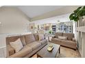 The living room has comfortable seating and a seamless transition into the dining and kitchen areas at 2409 S Halifax Way, Aurora, CO 80013