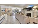 Open concept living room with a fireplace, comfortable seating, and seamless flow into the dining and kitchen areas at 2409 S Halifax Way, Aurora, CO 80013