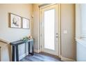 Inviting entryway with sleek console table, art, and modern finishes create a welcoming first impression at 7928 E 54Th Pl, Denver, CO 80238