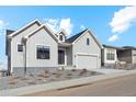 Gray modern farmhouse exterior with two-car garage and landscaping at 616 Scrubjay Cir, Castle Rock, CO 80104