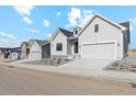 Street view of attractive light gray single-Gathering home featuring a two-car garage and minimalist landscaping at 616 Scrubjay Cir, Castle Rock, CO 80104