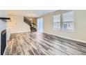 Open-concept living room featuring modern wood floors, large windows, and a staircase at 2356 W 165Th Pl, Broomfield, CO 80023