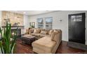 Comfortable living room with a stone fireplace and a large sectional sofa at 8691 Bluebunch Ct, Parker, CO 80134