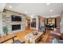 Spacious living room with stone fireplace, hardwood floors, and an open layout at 12752 W Asbury Pl, Lakewood, CO 80228