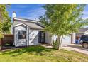 Charming home with a well-maintained lawn and mature tree shading the front yard and entry at 9805 Garrison Ct, Broomfield, CO 80021