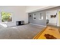 Spacious living room with a window, plush carpet, and open access to other rooms at 9805 Garrison Ct, Broomfield, CO 80021
