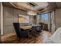 Formal dining room showcases a decorative ceiling, modern lighting, and a large window, creating an elegant dining experience at 25312 E Glasgow Pl, Aurora, CO 80016