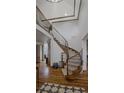 Grand foyer staircase with wood and wrought iron detailing and soaring ceilings at 25312 E Glasgow Pl, Aurora, CO 80016