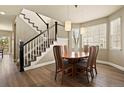 Open dining area featuring a staircase, stylish lighting, and a hardwood floor finish at 11007 Meadowvale Cir, Highlands Ranch, CO 80130