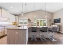 Bright, updated kitchen with stone countertops, modern pendant lighting, stainless steel appliances, and hardwood floors at 2235 Stonecrop Way, Golden, CO 80401