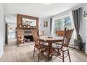 Cozy dining room with a brick fireplace, charming decor, and ample natural light at 11827 Brook Rd, Golden, CO 80403