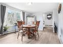 Inviting dining room featuring hardwood floors, bright natural light, and a classic wooden table at 11827 Brook Rd, Golden, CO 80403