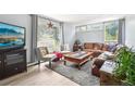 Comfortable living room with large windows, neutral tones, and a cozy seating arrangement at 11827 Brook Rd, Golden, CO 80403