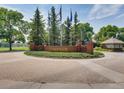 Riverwalk community entrance sign surrounded by flags and mature trees at 2951 W Riverwalk Cir # N, Littleton, CO 80123