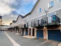 Modern townhome row featuring private balconies over attached one-car garages at 2951 W Riverwalk Cir # N, Littleton, CO 80123