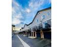 Modern townhouse exterior features private balconies above garages, enhanced by clean lines and updated facades at 2951 W Riverwalk Cir # N, Littleton, CO 80123
