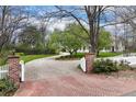 Long gravel driveway leading to a charming home with mature trees and landscaping at 4682 S Franklin St, Englewood, CO 80113