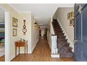 Inviting foyer with hardwood floors, a staircase, and elegant decor at 4682 S Franklin St, Englewood, CO 80113